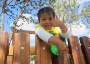 Happy girl receiving assistance from a Hearts of Gold program in Cuenca, Ecuador.